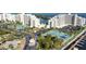 Aerial view showcases condo buildings, tennis courts, a marina, and tropical landscaping at 6035 Sea Ranch Dr # 411, Hudson, FL 34667