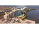 Aerial view featuring a complex, swimming pool, boat docks, and waterfront views at 6035 Sea Ranch Dr # 411, Hudson, FL 34667