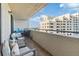 Relaxing balcony with a seating area and a beautiful view of a neighboring building and blue skies at 6035 Sea Ranch Dr # 411, Hudson, FL 34667