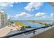 Balcony view of waterfront, blue sky, palm trees, and community pool at 6035 Sea Ranch Dr # 411, Hudson, FL 34667