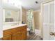 Well-lit bathroom with a single vanity, decorative mirror, and shower-tub combination with a curtain at 6035 Sea Ranch Dr # 411, Hudson, FL 34667