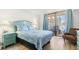 Charming bedroom with balcony access, a plush bed, and lovely side tables at 6035 Sea Ranch Dr # 411, Hudson, FL 34667
