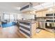 Open kitchen featuring wooden cabinets, stainless steel appliances, and a breakfast bar with blue detailing at 6035 Sea Ranch Dr # 411, Hudson, FL 34667