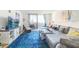 Bright and airy living area showcasing a large, comfortable couch and balcony access at 6035 Sea Ranch Dr # 411, Hudson, FL 34667
