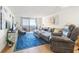Inviting living space with balcony access, a plush sofa, and a cozy armchair at 6035 Sea Ranch Dr # 411, Hudson, FL 34667