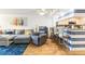 Cozy living room featuring a comfortable gray couch, chair and adjacent breakfast bar with seating at 6035 Sea Ranch Dr # 411, Hudson, FL 34667