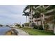 Waterfront view from walkway and waterfront complex with palm trees and clear water at 6035 Sea Ranch Dr # 411, Hudson, FL 34667