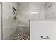 Modern shower with tiled walls, a mosaic shower floor, a modern showerhead, and a tiled wall niche at 625 Lafayette Blvd, Oldsmar, FL 34677
