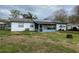 View of backyard featuring solar panels, a screened porch, and a utility shed at 6361 Boxwood St, Brooksville, FL 34602