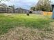 Backyard with a fire pit and full perimeter wooden fence at 6361 Boxwood St, Brooksville, FL 34602