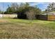 View of backyard with trees, fences, bench and grass at 6361 Boxwood St, Brooksville, FL 34602