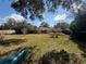 Large backyard with fencing and tree coverage provides a relaxing outdoor space at 6361 Boxwood St, Brooksville, FL 34602