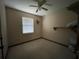 Bedroom featuring a ceiling fan, window, and wall-to-wall carpet at 6361 Boxwood St, Brooksville, FL 34602