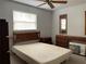 Bedroom with a ceiling fan, a window, and furniture including a dresser and a bedframe at 6361 Boxwood St, Brooksville, FL 34602