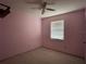 Bedroom featuring a ceiling fan, window, and wall-to-wall carpet at 6361 Boxwood St, Brooksville, FL 34602