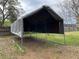 View of metal carport surrounded by grass and fence at 6361 Boxwood St, Brooksville, FL 34602