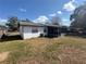 Rear exterior of the home featuring a screen porch at 6361 Boxwood St, Brooksville, FL 34602