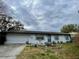 Charming single-story home featuring a well-maintained lawn and a decorative garden in the front yard at 6361 Boxwood St, Brooksville, FL 34602