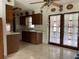 Kitchen with wooden cabinets, white counters, tile flooring, and direct access to the patio at 6361 Boxwood St, Brooksville, FL 34602
