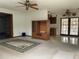 Living room featuring neutral carpet, ceiling fans, and entry to the kitchen area at 6361 Boxwood St, Brooksville, FL 34602