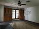 Living room with built-in shelves, ceiling fan, and access to the backyard at 6361 Boxwood St, Brooksville, FL 34602