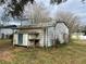 Side view of shed with door, table, and some windows at 6361 Boxwood St, Brooksville, FL 34602