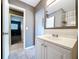 Bright bathroom with white vanity, mirror, and view into bedroom at 6402 S Cameron Ave, Tampa, FL 33616