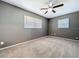 Bedroom features neutral carpet, gray walls, and two windows at 6402 S Cameron Ave, Tampa, FL 33616