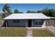 Charming single story home with a modern metal roof and gray brick exterior at 6402 S Cameron Ave, Tampa, FL 33616