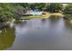 Aerial view of a community pool and lakefront recreational area at 6440 Spring Flower Dr # 11, New Port Richey, FL 34653