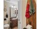 Bathroom showing a rustic vanity with a vessel sink and wood plank accent wall at 6440 Spring Flower Dr # 11, New Port Richey, FL 34653