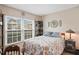 Cozy bedroom featuring a charming floral quilt and a bright window view at 6440 Spring Flower Dr # 11, New Port Richey, FL 34653