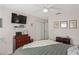 Cozy bedroom features ceiling fan, tv, and closet with sliding doors at 6440 Spring Flower Dr # 11, New Port Richey, FL 34653
