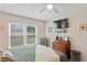 Comfortable bedroom with a ceiling fan and large window allowing for lots of natural light at 6440 Spring Flower Dr # 11, New Port Richey, FL 34653