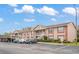 Exterior of condo building with guest parking, covered parking, and well-maintained landscaping at 6440 Spring Flower Dr # 11, New Port Richey, FL 34653