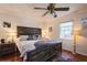 Cozy bedroom features a comfortable bed, hardwood floors, and soft, natural lighting at 6710 Devonshire Ln # 10A, New Port Richey, FL 34653