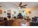 Spacious living room with hardwood floors, comfortable seating, and large ceiling fan at 6710 Devonshire Ln # 10A, New Port Richey, FL 34653