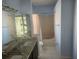 Bathroom featuring dual sinks, a soaking tub, and a toilet at 7125 Silverwood Dr, New Port Richey, FL 34654
