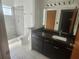 Bathroom showcasing granite countertops, a tiled walk-in shower, and modern fixtures at 7125 Silverwood Dr, New Port Richey, FL 34654