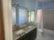 Bathroom featuring dual sinks, a soaking tub, and a toilet at 7125 Silverwood Dr, New Port Richey, FL 34654