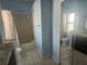 Bright bathroom featuring white tiled floors, a shower and tub combination, and a neutral color scheme at 7125 Silverwood Dr, New Port Richey, FL 34654