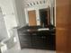 Bathroom with a black marble vanity and mirror at 7125 Silverwood Dr, New Port Richey, FL 34654