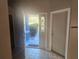 Foyer with open doorway to the exterior, tile flooring, and access to other rooms at 7125 Silverwood Dr, New Port Richey, FL 34654