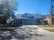 Charming single-Gathering home featuring a blue exterior, a two-car garage, and a well-maintained front yard at 7125 Silverwood Dr, New Port Richey, FL 34654