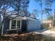 This single story property features a front-entry garage, garden bed, and mature trees at 7125 Silverwood Dr, New Port Richey, FL 34654