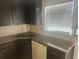 A kitchen showcases dark wood cabinets, granite countertops, and a stainless steel sink at 7125 Silverwood Dr, New Port Richey, FL 34654