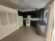 Kitchen with dark cabinetry, tile flooring, and white appliances, next to a large closet at 7125 Silverwood Dr, New Port Richey, FL 34654