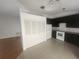 Kitchen with white appliances, dark cabinets, and a view into the living space at 7125 Silverwood Dr, New Port Richey, FL 34654
