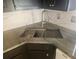 A stainless steel sink sits atop the granite countertop and is surrounded by white subway tile at 7125 Silverwood Dr, New Port Richey, FL 34654