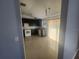 Modern kitchen with dark cabinets, tile flooring, and white appliances at 7125 Silverwood Dr, New Port Richey, FL 34654